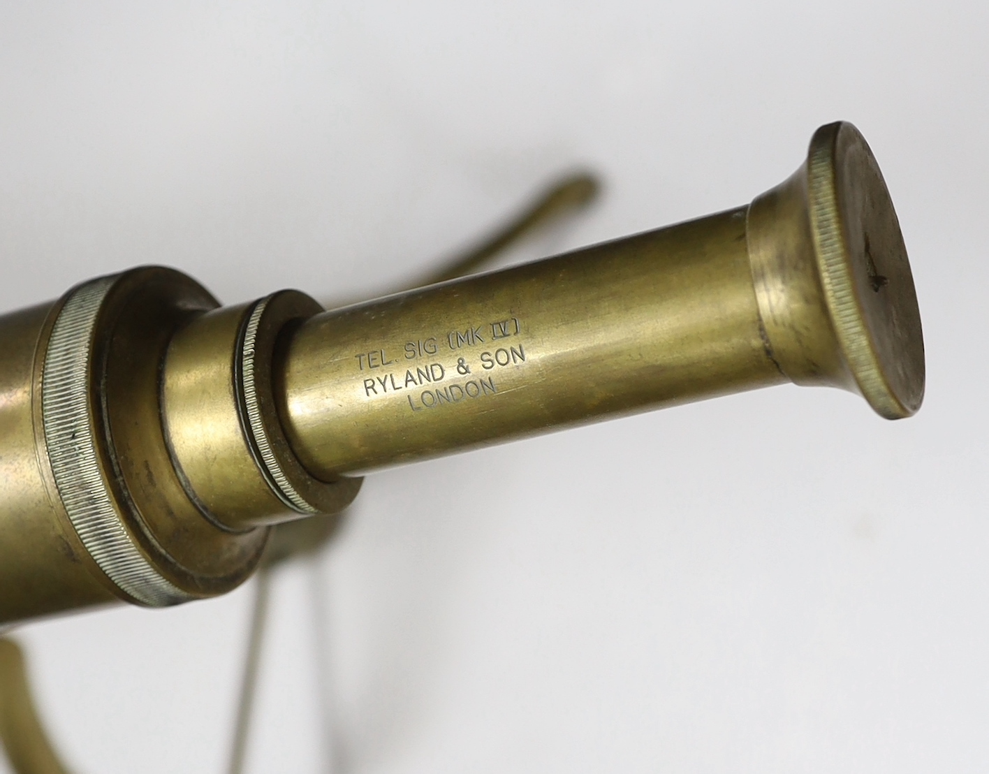 A brass tripod telescope, 65cm wide